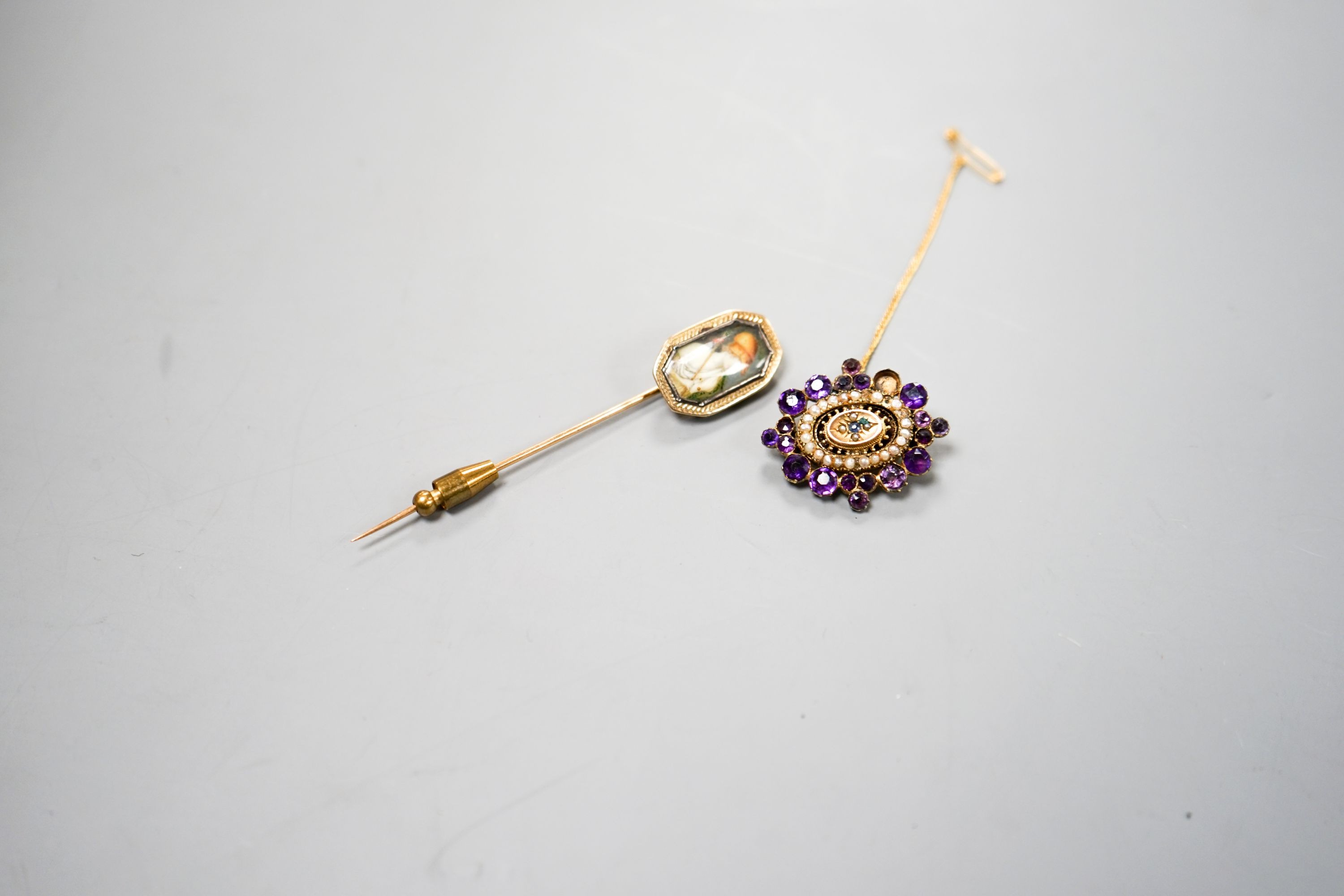A Victorian yellow metal, amethyst and split pearl set brooch, 31mm and a stick pin.